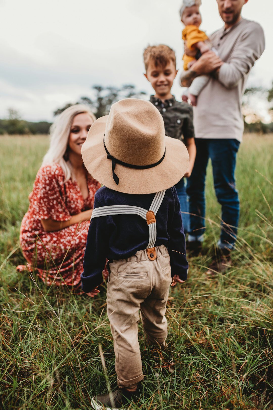 Photographer taking a portrait of a local family outdoors