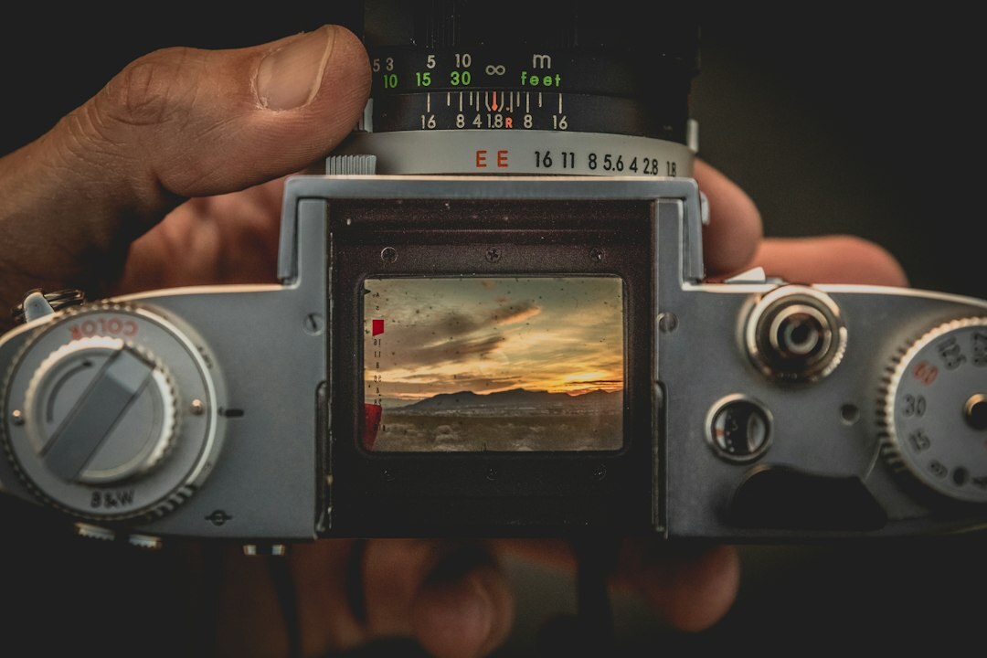 Close-up of hands holding a vintage film camera