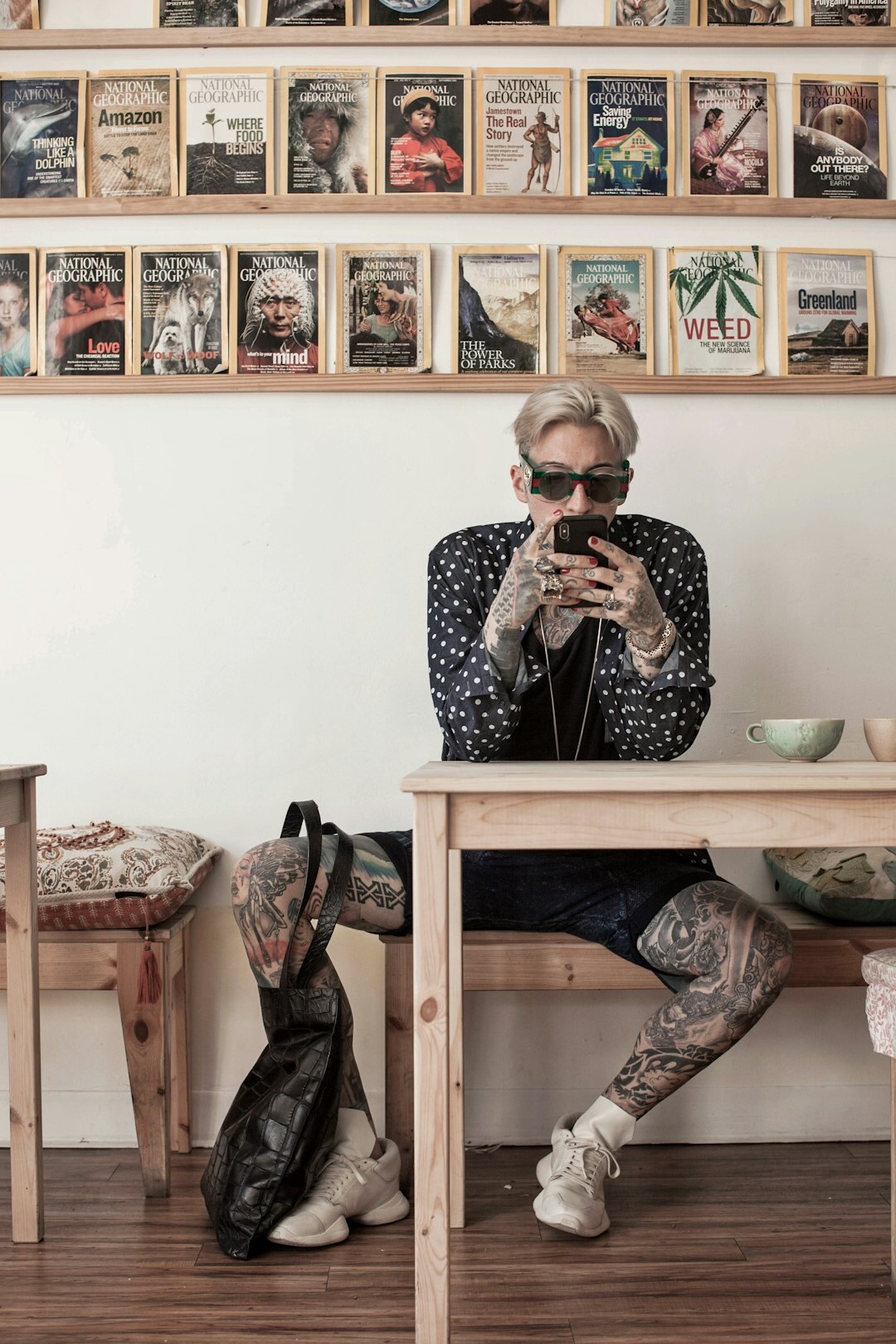 Man reviewing documentary photographs on a laptop in a cafe